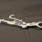 white machine part with metal and screws